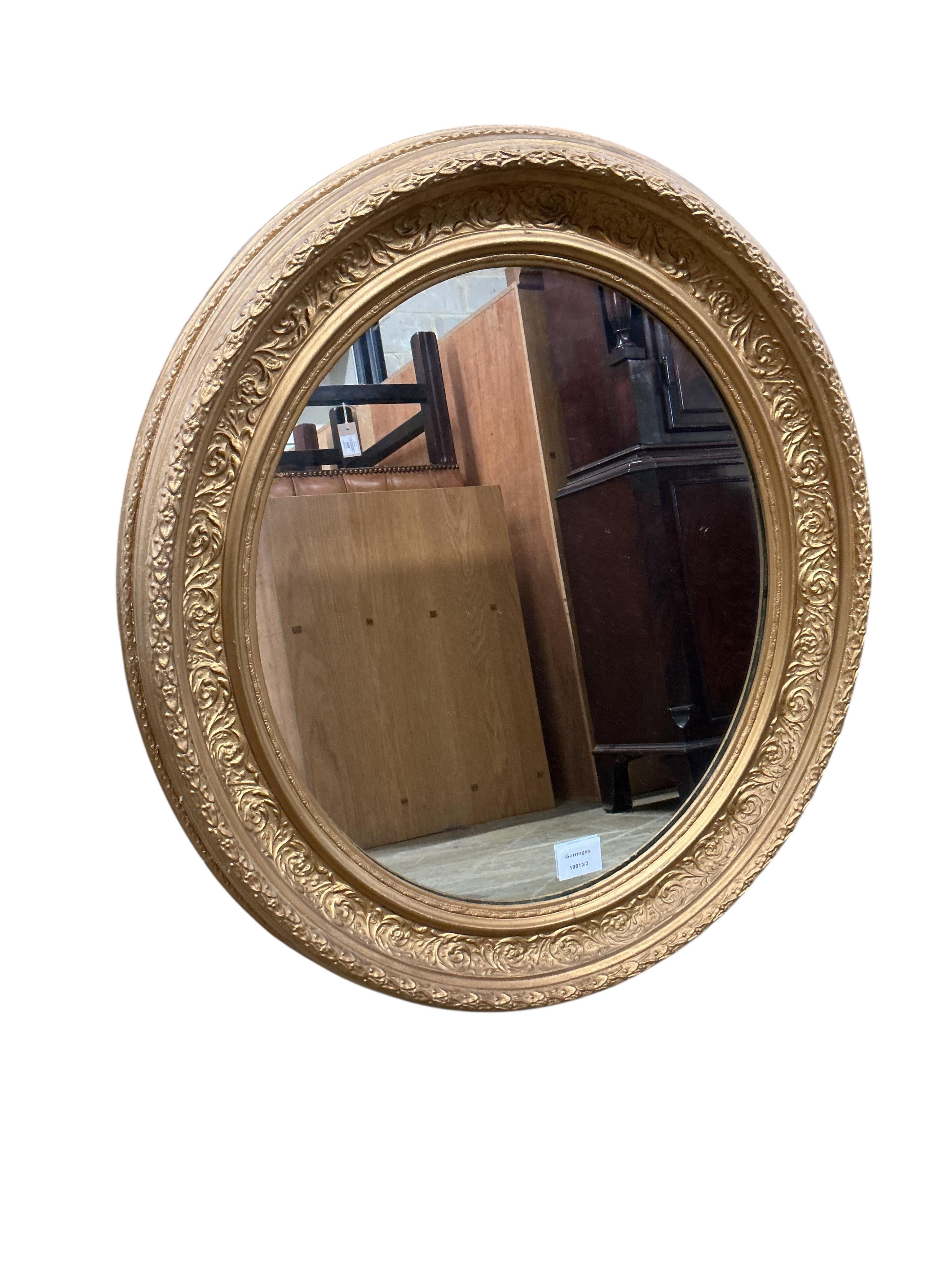 A gilt and composition oval wall mirror, width 60cm, height 66cm